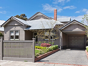 Neutral Weatherboard with Grey Window Trims and Front Garden and Concrete Driveway and Grey Garage